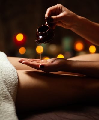 close-up-therapist-pouring-oil-spa-treatment